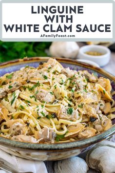 linguine with white clam sauce in a bowl on top of garlic and parsley