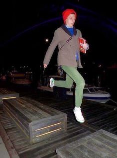 a young man is jumping on the dock