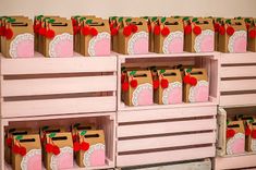 several boxes with cherries on them are lined up against the wall in front of each other