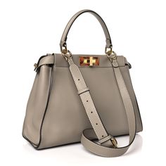 This is an authentic FENDI Vitello Seta Plexiglass Tortoise Medium Peekaboo Iconic Satchel in Tortora. This chic tote is finely crafted of soft taupe grey calfskin leather. This bag features a gold metal and tortoiseshell resin squared turn-lock on either side of the looping top handle that open to a microfiber interior with a zipper pocket. It can be carried as a shoulder bag with the optional strap or as a tote by the handle. Fendi Peekaboo Bag, Fendi Tote Bag, Fendi Tote, Fendi Shoulder Bag, Fendi Peekaboo, Taupe Grey, Python Print, Shopper Tote, Boston Bag