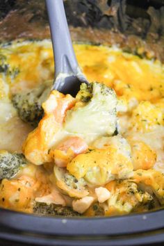 broccoli and chicken casserole being stirred with a spoon