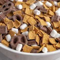 a white bowl filled with cereal and marshmallows