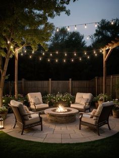 an outdoor fire pit surrounded by chairs and lights