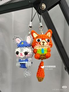 two small crocheted animals hanging from hooks