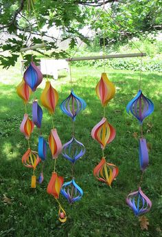 several colorful wind chimes hanging from a tree