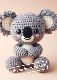 a crocheted koala bear sitting on top of a table