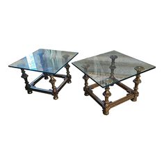 two tables with glass top and metal legs on each side, one is turned upside down