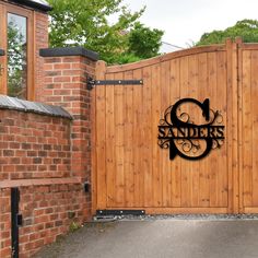 a wooden gate with the name sanderss on it