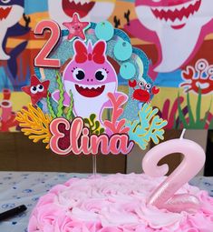 a birthday cake with pink frosting and an animal topper that says 2 is for elma