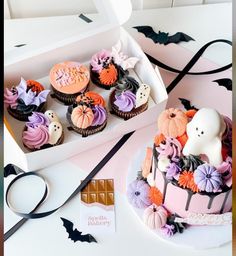 cupcakes decorated with halloween decorations in a box