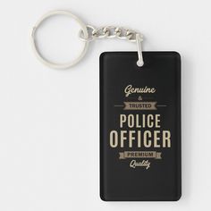 a police officer keychain with the words genuine, trusted and proud on it