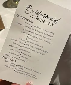 a person holding up a wedding itinerary