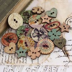 a pile of wooden buttons sitting on top of a piece of paper