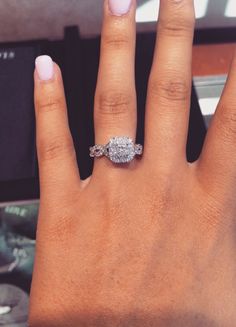 a woman's hand with a diamond ring on it