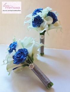 two blue and white flowers are on the bridal bouquet, which is attached to a silver tube