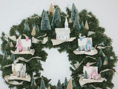 a wreath with houses and trees on it