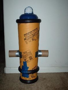 a fire hydrant made out of cardboard and duct tape is shown in front of a white wall