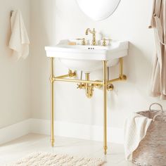 a white sink sitting under a mirror in a bathroom