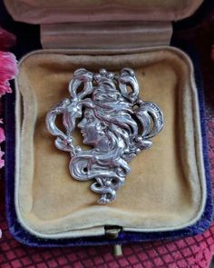 This is a beautiful sterling silver Art Nouveau style brooch. It depicts an elegant lady with flowing locks and mistletoe.  The brooch is fully hallmarked with on the front. The date letter R for 1991. This is a vintage piece inspired by Art Nouveau Style. The brooch measures 3.8 cm high and 3.3 cm wide.  It weighs 8.78 grams.  The brooch is in great condition with minimal to light signs of wear. It has a fully working safety catch on the back. Silver Art Nouveau Brooches For Gifts, Silver Art Nouveau Brooches As Gift, Silver Art Nouveau Brooch, Elegant Lady, Art Nouveau Style, Letter R, Silver Art, Lighted Signs, Style Art