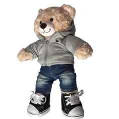 a teddy bear dressed in jeans and sneakers with a hoodie on it's head