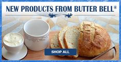 a wooden cutting board topped with bread and butter