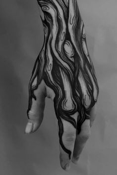 a person's hand with black and white designs on it