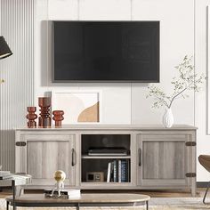 a living room scene with focus on the entertainment center and television mounted to the wall