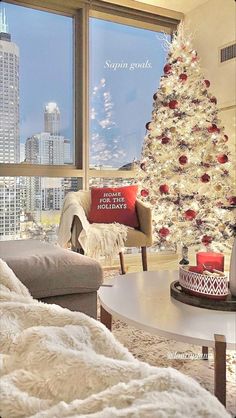 a living room filled with furniture and a christmas tree in front of a large window