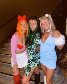 three women dressed in costumes posing for the camera