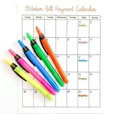 a calendar with pens and markers on it for the october, november, and december