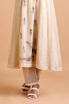 Ivory tunic in jute silk base with multicolored floral thread and dori embroidery. Comes with an inner. - Aza Fashions Beige Chikankari Embroidery Kurta For Summer, Summer Beige Kurta With Chikankari Embroidery, Beige Chikankari Kurta For Summer, Cream Dress With Embroidered Border For Festive Occasions, Festive Cream Dress With Embroidered Border, Beige Cotton Dupatta With Floral Embroidery, Cream Kurta With Dupatta For Spring, Spring Cream Kurta With Dupatta, Off White Dress With Dupatta For Spring