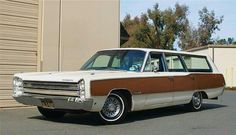 an old station wagon parked in front of a building