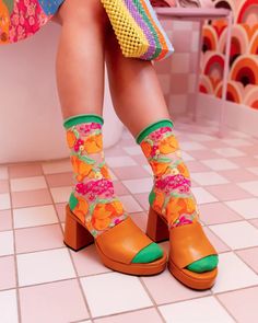 Juicy oranges paired with vibrant florals make our orange print sheer sock the essence of Spring and Summer. With a watercolor style illustration for an artsy effect, your feet will love the explosion of color and print. Finished with a green heel and cuff and a roll-top cuff for an effortless vibe.    One Size. Reco Sock Candy, 80s Socks, Orange Sandals, Slouch Socks, Nylon Socks, Pointy Heels, Felt Cowboy Hats, Sheer Socks, Green Heels