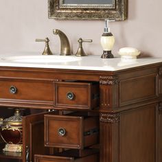 a bathroom vanity with two drawers and a mirror on the wall above it is shown