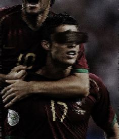 two soccer players are hugging each other in the middle of an image with words on it