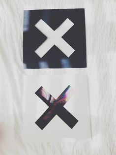 two stickers on a white sheet with black and white squares in the middle one has an x