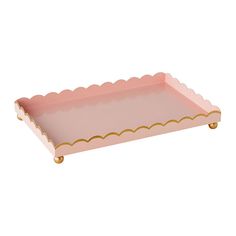 a pink tray with scalloped edges and gold trim