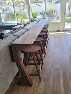 a long wooden table sitting in the middle of a living room