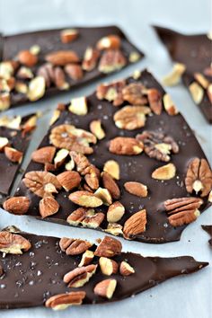 chocolate barkle with nuts and almonds on top, ready to be cut into pieces