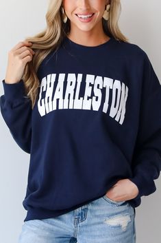 Calling all Charleston residents, the Navy Charleston Sweatshirt was made just for you! This comfy sweatshirt is designed with a soft and stretchy knit with a fleece interior. It features a crew neckline, long sleeves, a relaxed fit, and the word "Charleston" on the front. Style the Navy Charleston Sweatshirt with your favorite denim and sneakers for a casual look! Soft + Stretchy Knit Fabrication Fleece Interior "Charleston" Graphic Crew Neckline Long Sleeves Relaxed Fit 80% Cotton, 20% Polyest Long Sleeve Text Print Sweatshirt For Loungewear, Long Sleeve Sweatshirt With Text Print For Loungewear, Crew Neck French Terry Sweatshirt With Text Print, French Terry Crew Neck Sweatshirt With Text Print, Collegiate Long Sleeve Sweatshirt For Loungewear, Collegiate Text Print Sweatshirt For Fall, Long Sleeve Fall Campus Sweats, Fall Campus Long Sleeve Sweats, Game Day Crew Neck Sweatshirt With Lettering