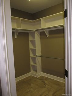 an empty walk - in closet with shelves and shelving