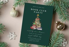 a book club party is set up with christmas decorations and books on the table next to it