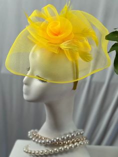 Step into style with our enchanting yellow Fascinator Hat, the ultimate statement piece for any sophisticated soiree. Crafted with the utmost care, this hat exudes elegance and is guaranteed to turn heads at any event. The vibrant yellow hue symbolizes warmth, joy, and positivity, making it a perfect companion for Derby days, church services, weddings, and even royal tea parties. The whimsical floral design adds a touch of grace and femininity, while the lightweight mesh ensures it's as comforta Yellow Mini Hat For Royal Ascot Races, Yellow Mini Hats For Races At Royal Ascot, Yellow Fascinator For Royal Ascot, Yellow Summer Fascinator For Races, Yellow Fascinator For Royal Ascot Races, Yellow Short Brim Fascinator For Church, Spring Yellow Fascinator Hat, Yellow Fitted Short Brim Fascinator, Yellow Church Fascinator With Short Brim