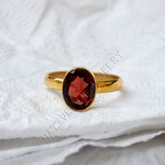 Hessonite garnet gold ring, 14K yellow gold garnet ring, natural oval cut gemstone jewelry, romantic gift ring, gold ring, wedding gift ring ------------------------------- Size/Dimension (Approx) : All Sizes Available Gemstone : Hessonite Garnet Stone Shape : Oval Stone Size (Approx) : 10x8 mm Stone Color : Red Pink ------------------------------- The 14K yellow solid gold bezel and solid yellow gold ring are both shined to an extremely high polish. All rings are packaged and shipped in a beautiful ring box. The main stone is natural, oval cut, hessonite garnet. The pictures have been enlarged to show the details. The price is for a 14k gold ring, if you want to order the ring in 18k or 22k gold please convo me prior to purchase. IMPORTANT NOTES This gold jewelry is custom made order jewe Oval Garnet Birthstone Ring For Wedding, Oval Garnet Ruby Ring As Gift, Gold Oval Ruby Birthstone Ring, Heirloom Garnet Oval Birthstone Ring, Oval Topaz Ring In 14k Gold As Gift, Oval Garnet Birthstone Ring, Oval Ruby Ring In 14k Gold As Gift, Elegant Oval Garnet Birthstone Ring, Oval Garnet Birthstone Ring As Gift