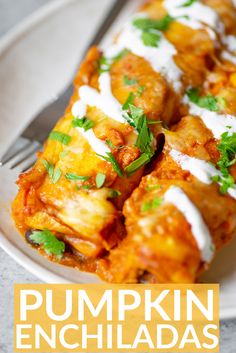 pumpkin enchiladas on a white plate with a fork