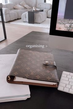 an open book sitting on top of a desk next to a keyboard