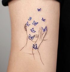 a woman's stomach with blue butterflies flying around her