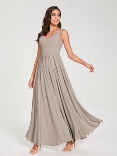 a woman wearing a long gray dress