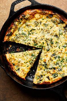 a pizza with cheese and herbs in a skillet