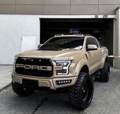 a beige truck parked in front of a garage